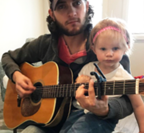 James and Zofia playing an acoustic guitar together